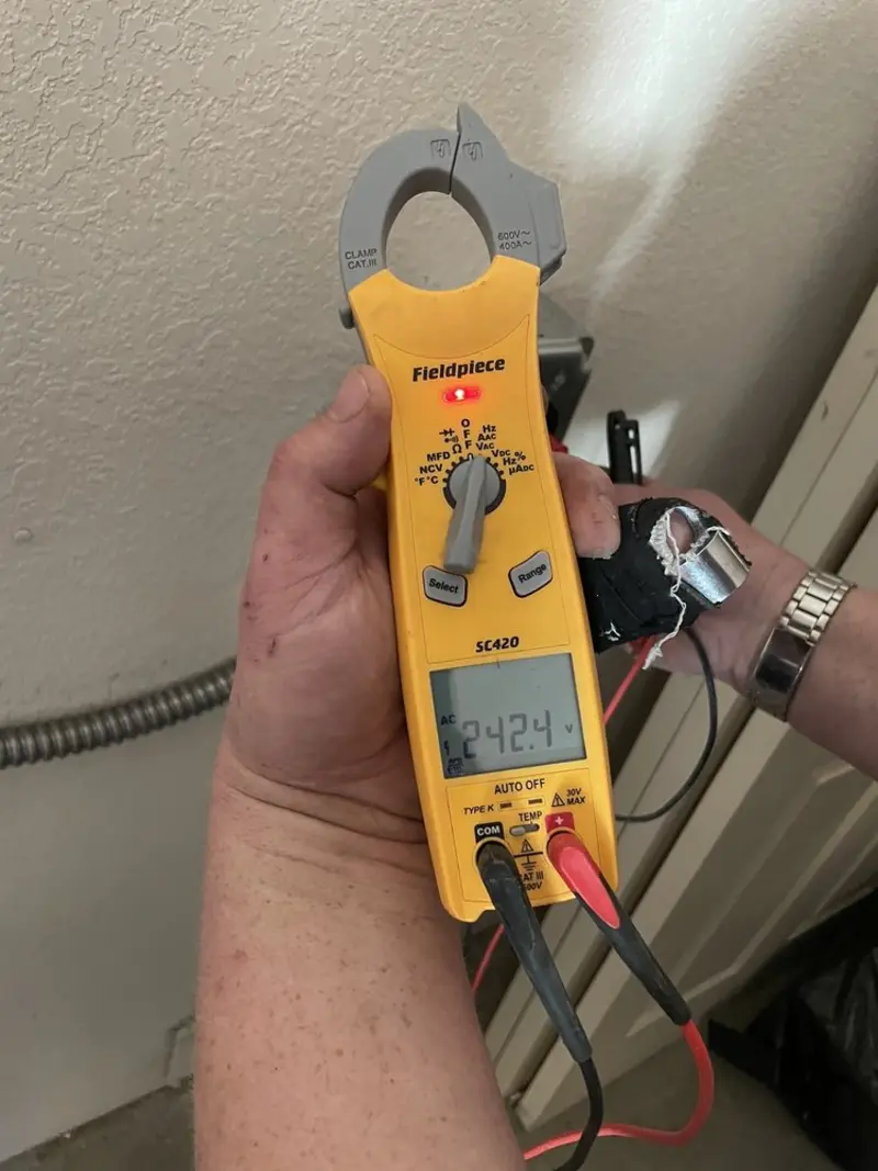 Voltage testing with clamp meter during Recessed Lighting Installation in George Mason